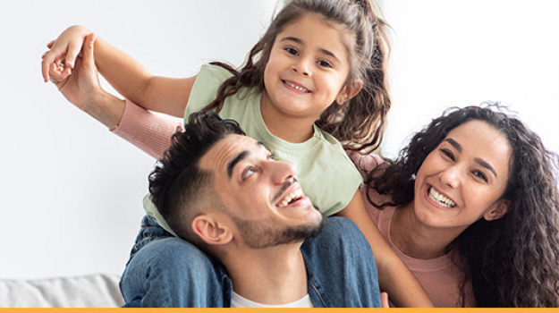 family with little girl on shoulders